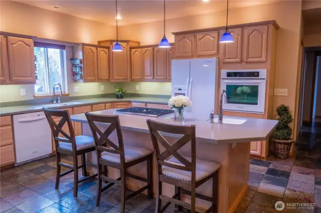 Kitchen with maple cabinets, corian counters & slate floors.  Chefs generally prefer propane cook top and a wall oven.