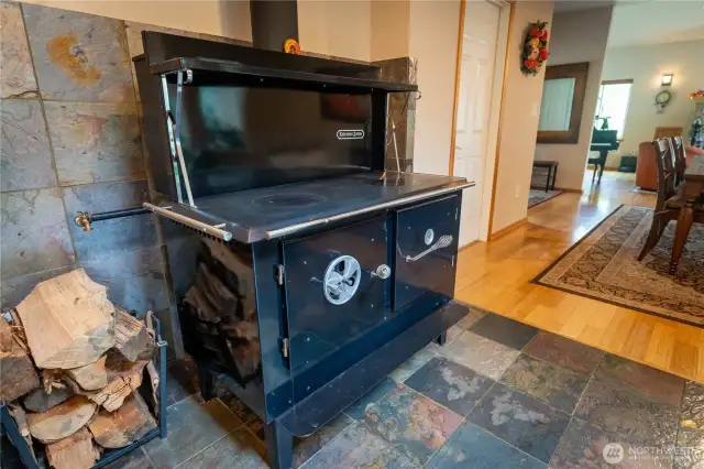 This valuable wood burning stove is something to brag about. It can heat the home, cook meals on the stove top,  and also bake goodies in the oven. At the rear are two giant tanks to heat water.