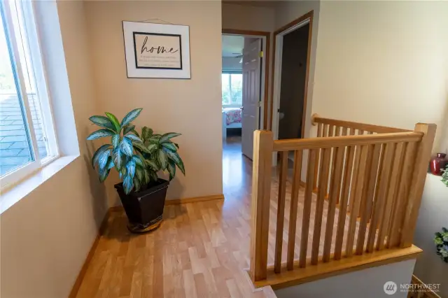 Landing on the upper floor looking towards the second bedroom and 3/4 bath to the right. Behind is the primary and third bedrooms.
