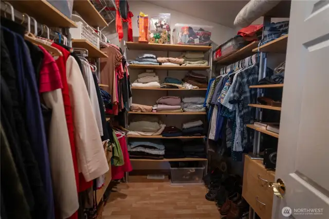 Primary bedroom walk-in closet with closet organizers.