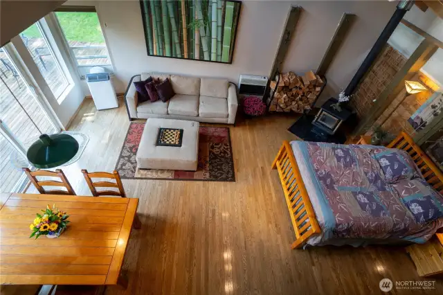 View of a portion of the ADU from loft with its own wood stove, kltchen and deck.
