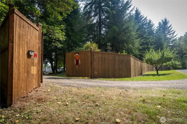 Gated entry with tall 8ft privacy fence & automatic gate opener.