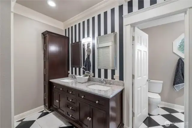 Updated primary bath featuring walk in closet and storage cabinets