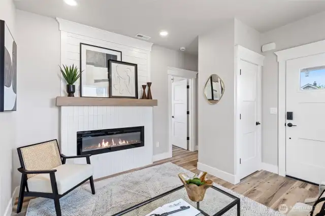 View from the living room showing the entry closet, fireplace & Primary Bedroom entry.