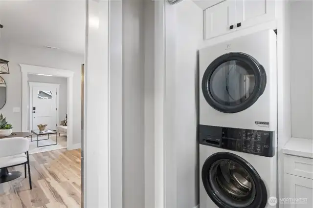 Laundry Room with full sized Laundry Tower with gas dryer, white shaker cabinets, & quartz countertop for folding.