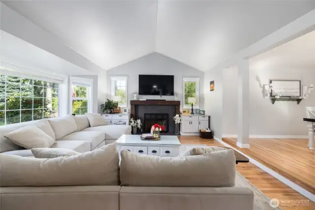 The living room has a gas fireplace and vaulted ceilings.