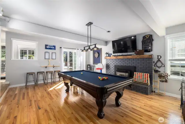 The family room has a fireplace and is currently a game room.