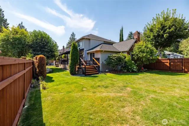 There is a lot of yard that is fenced along the side of the house.