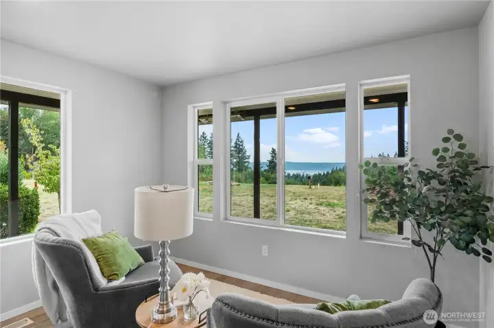 Cozy up in this flex space and read or watch nature in your sprawling yard with water view.