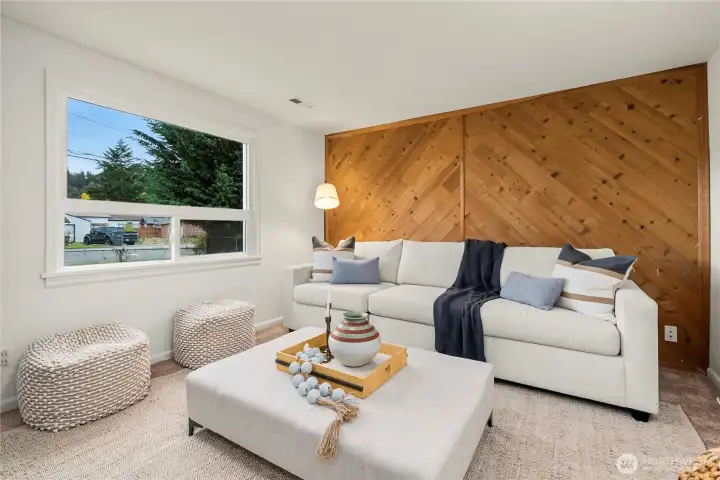 Living room features large window that overlooks the front yard and lets in lots of natural light.