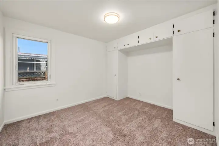 First bedroom features built in cupboards/wardrobe.