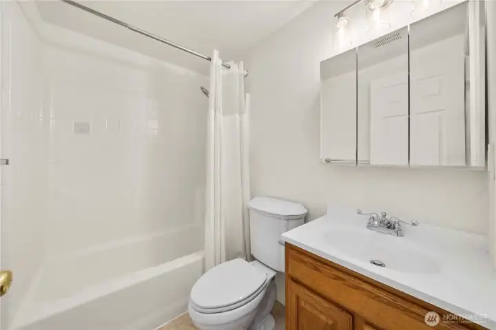 Full bath in hallway for other two bedrooms.