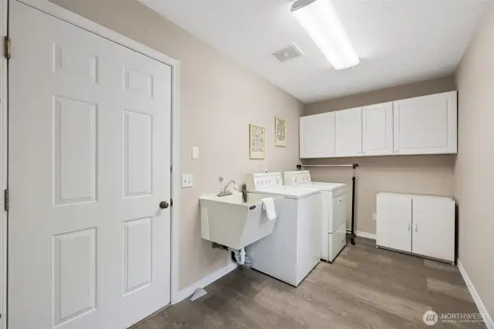 Utility room off kitchen with access to garage.