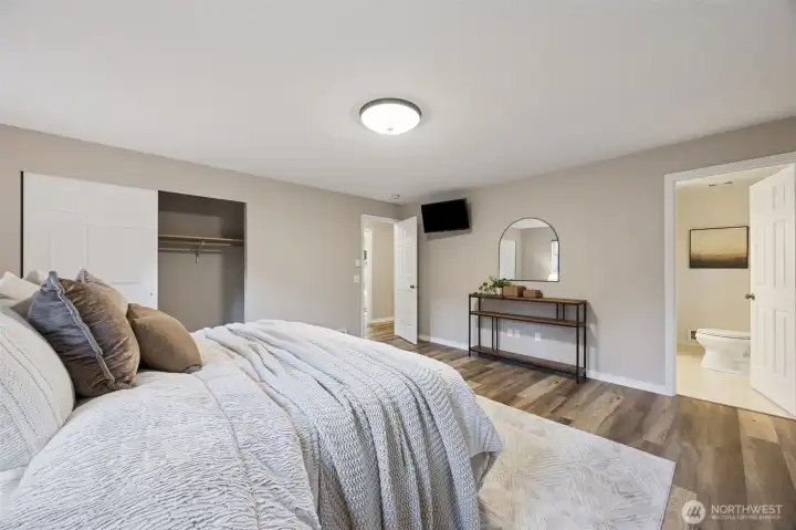 The primary bedroom features its own three quarter bath.