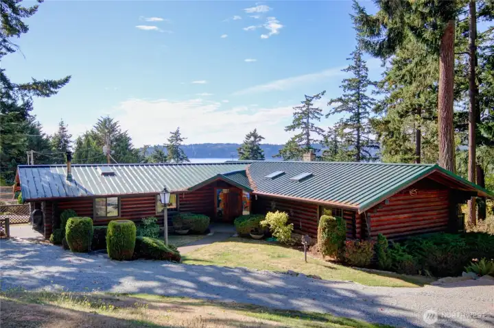 Beautiful log home framed by sweeping views of Skagit Bay.