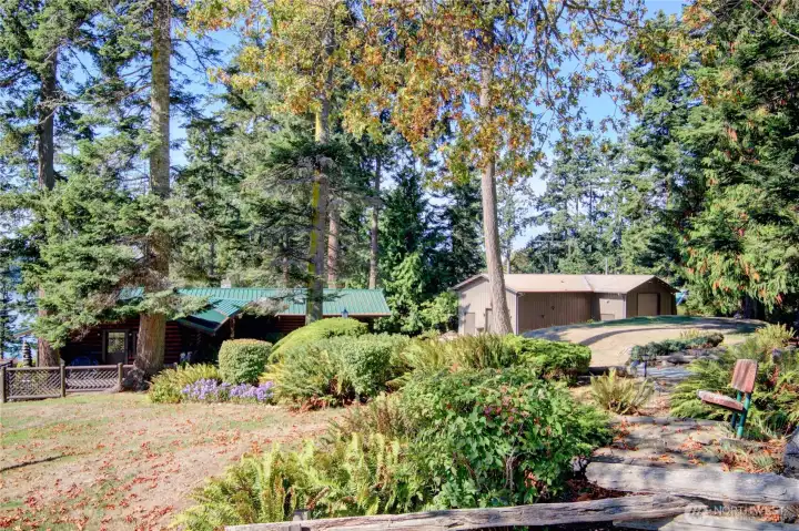 Log home and impressive 2-bay shop are set on beautifully landscaped lot with endless places to soak up the view.