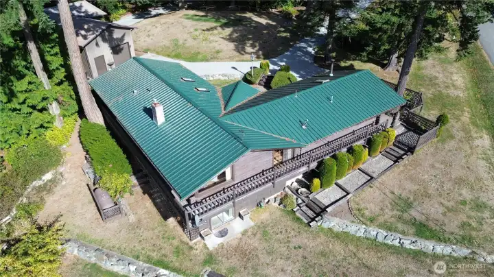 View of property's dual driveways and daylight basement side of home.