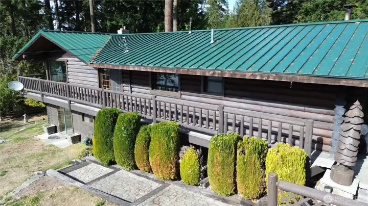 Main level balcony wraps around two sides and features steps down to basement slider patio.