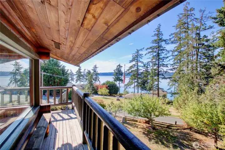 Wraparound balcony with space for small bench offers rail-side views of Skagit Bay just one block up from the water.