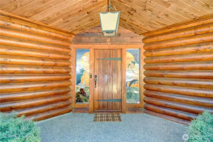 Unique stained-glass windows and front door complement the log home’s character and echo the artistic spirit of La Conner.