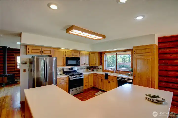 Kitchen features generous island, counter and storage space along with updated stainless-steel appliances.