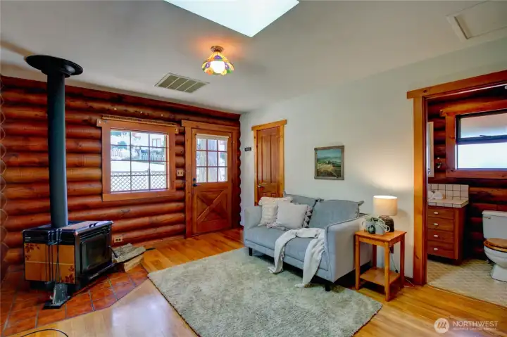 Cozy den with wood stove, skylight, ¾ bath, storage closet, and exterior door to side patio offers versatile uses.