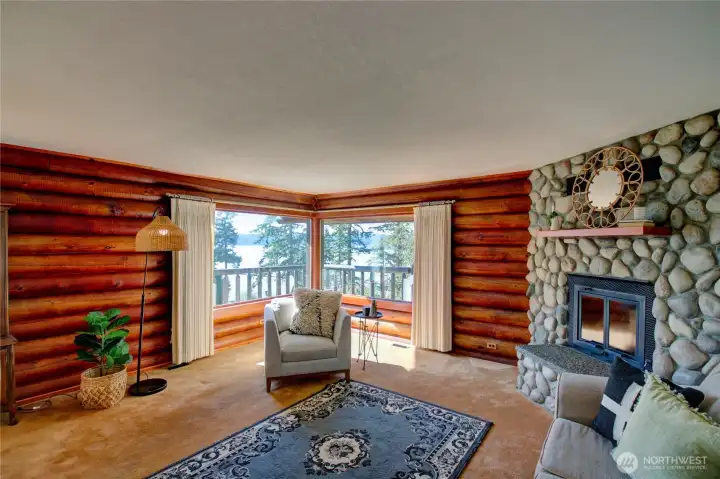 Living room with stunning Skagit Bay views and river rock gas fireplace.