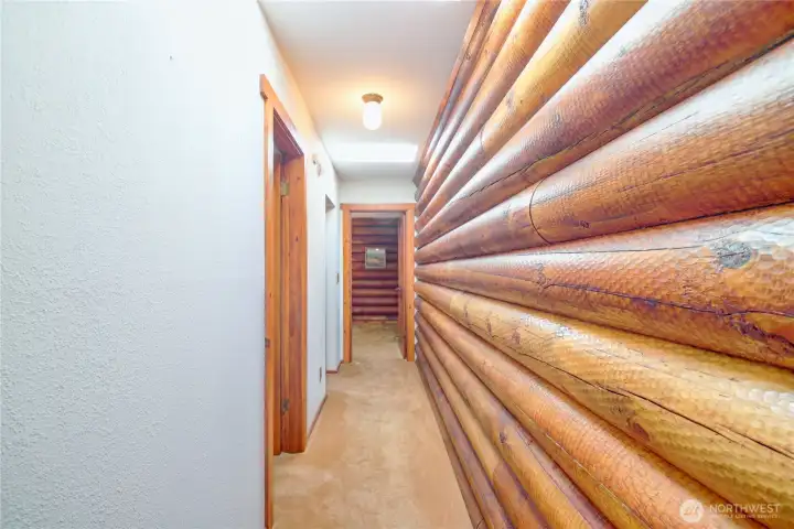 Hallway layout: primary bedroom at the end, second bedroom first on the left, with continental laundry and bathroom just beyond.