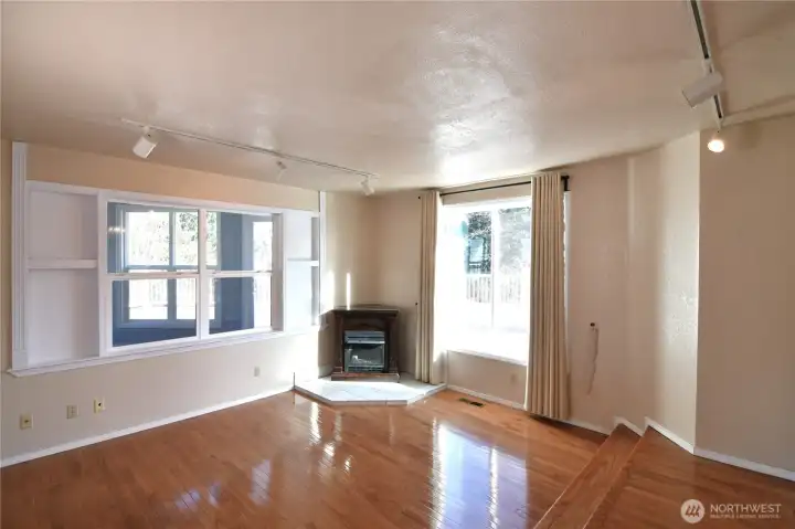 living room with fireplace overlooking backyard deck