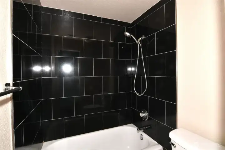 second floor full bathroom with tub/shower and title surround