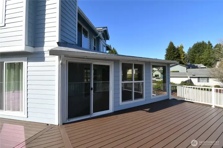light-filled sunroom with sliding glass door access to deck