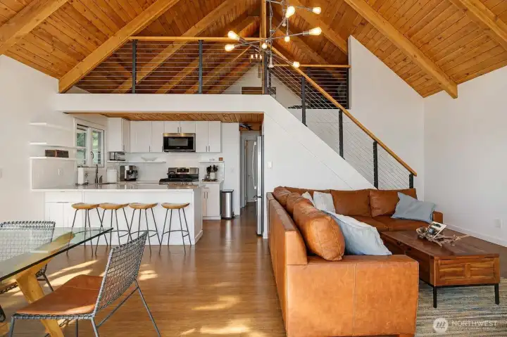 The open concept living area is enhanced with extended wood flooring, adjustable task lighting, and a stylish new chandelier fixture.