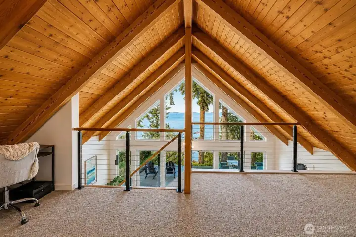 Updated loft featuring new carpet and enhanced lighting, offering a cozy and versatile space.