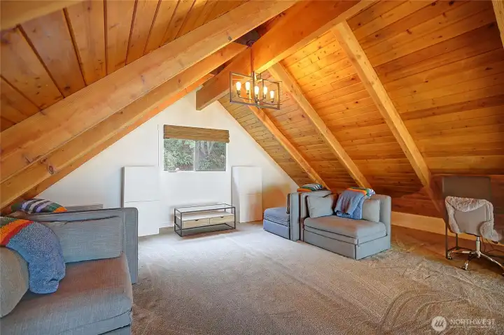 Updated loft featuring new carpet and enhanced lighting, offering a cozy and versatile space.