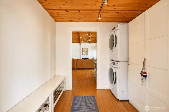 New entryway and mudroom with washer, dryer, and built-in cabinets provide convenient storage and functionality right from the front door.