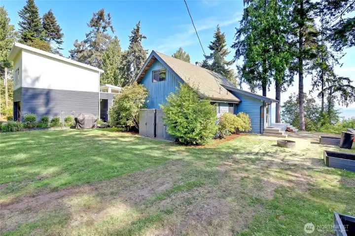 Enjoy the beach front yard with a fire pit and three flower beds, ready for your green thumb.