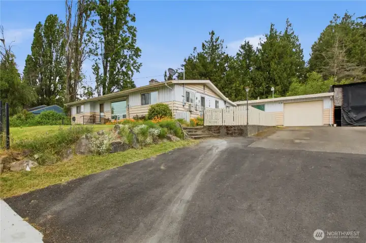 Front of the home and garage with covered RV parking