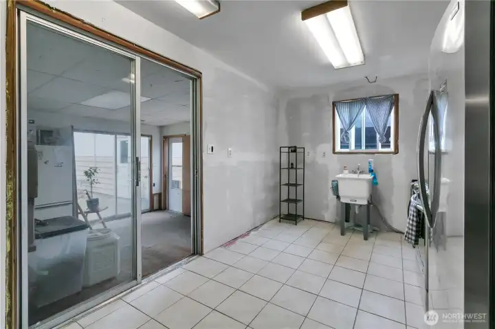 Kitchen with new tile floors and ready for your personal touch on cabinets and countertops.