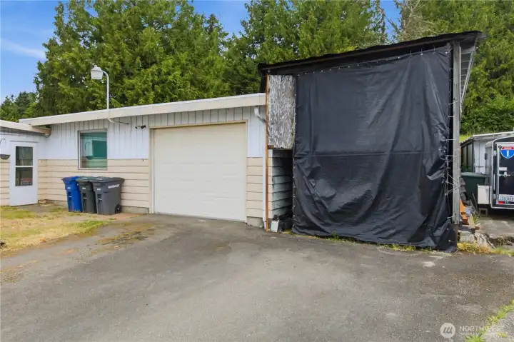 A spacious 1,080 sq ft garage/shop offers endless possibilities, already plumbed for a ½ bath and complemented by covered RV parking.