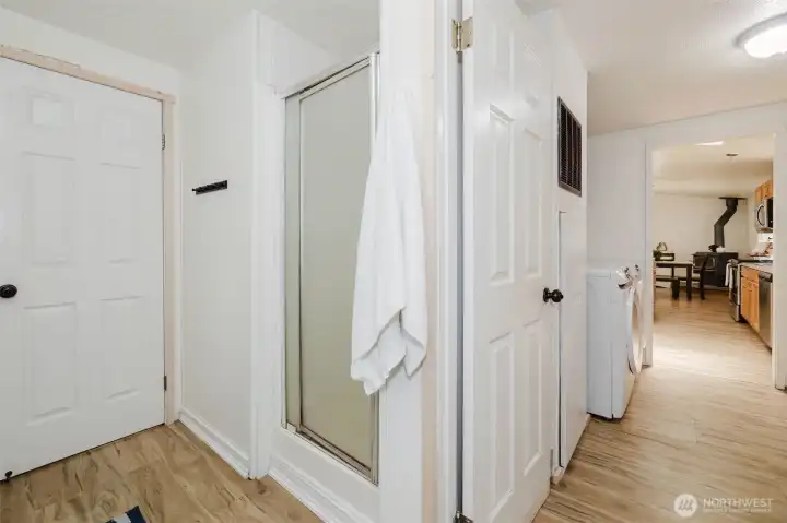 Separate shower in primary bath. Door leads out of primary bath into utility room.