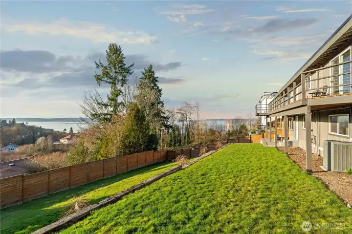 Large yard with newer landscaping just now taking off