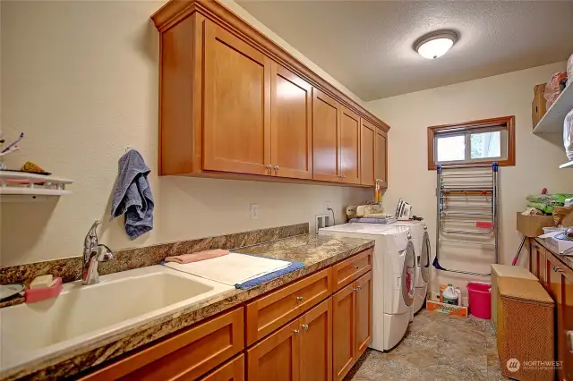 Laundry and utility room features plenty of storage space and a utility sink