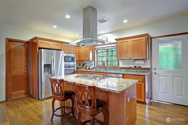 Beautiful kitchen with island and eating space.  Stainless steel appliances stay with the home