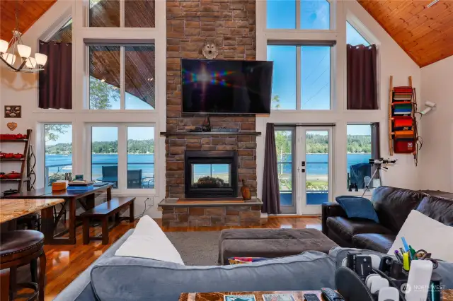 The greatroom has floor to ceiling windows and a see-through fireplace.