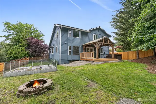 Large and private fully-fenced back yard with newer covered deck, firepit, planters, and shed!