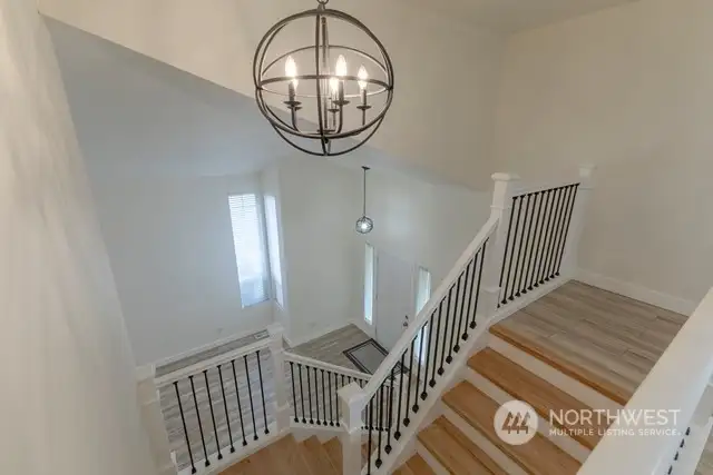 New hardwood floors on stairs with beautiful banisters/railings.