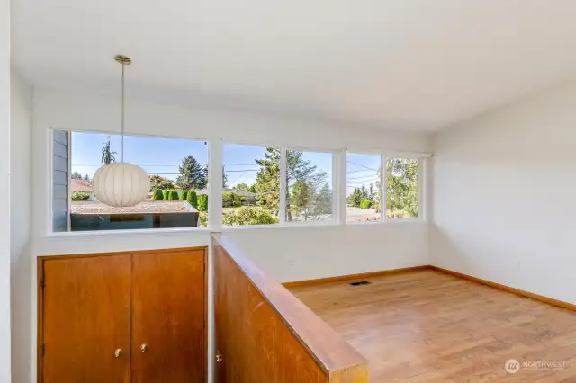 Entry with a few stairs up to the main level.  Partial view of Puget Sound from living room window.