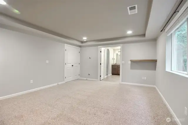 Spacious primary bedroom with French doors leading into room, as well as French doors also opening to 5 pc ensuite bathroom