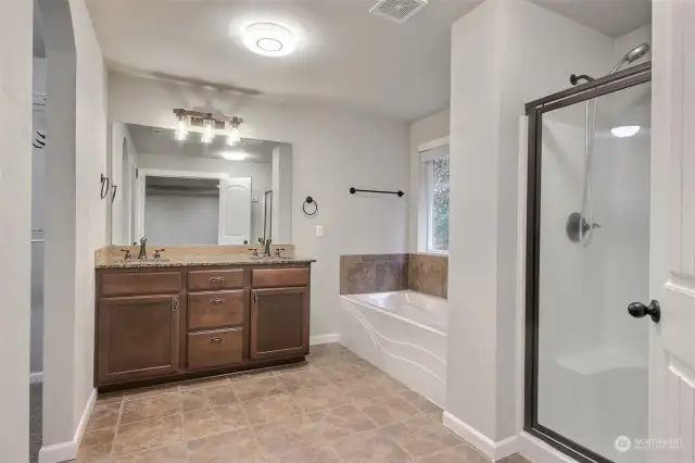 Five piece ensuite with dual sinks, walk-in closet, spa like shower, large soaking tub, granite counter tops, and tile floor.