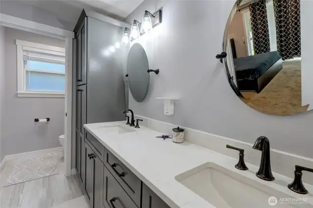 Primary Bathroom with dual vanities, quartz counters, toilet room, tub & shower, lots of counter space and storage.